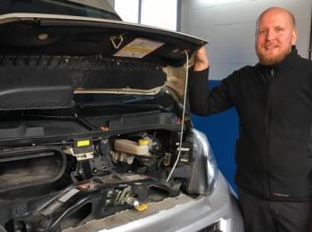 Mitarbeiter vor Auto mit offener Haube